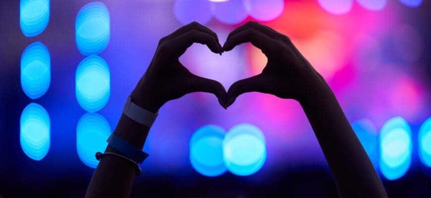 Hands,Form,Heart,Shape,At,Music,Fest,,Silhouetted,Against,Vibrant