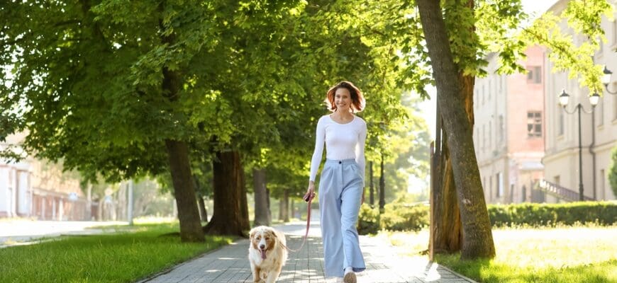 Happy,Young,Woman,With,Cute,Australian,Shepherd,Dog,Walking,In